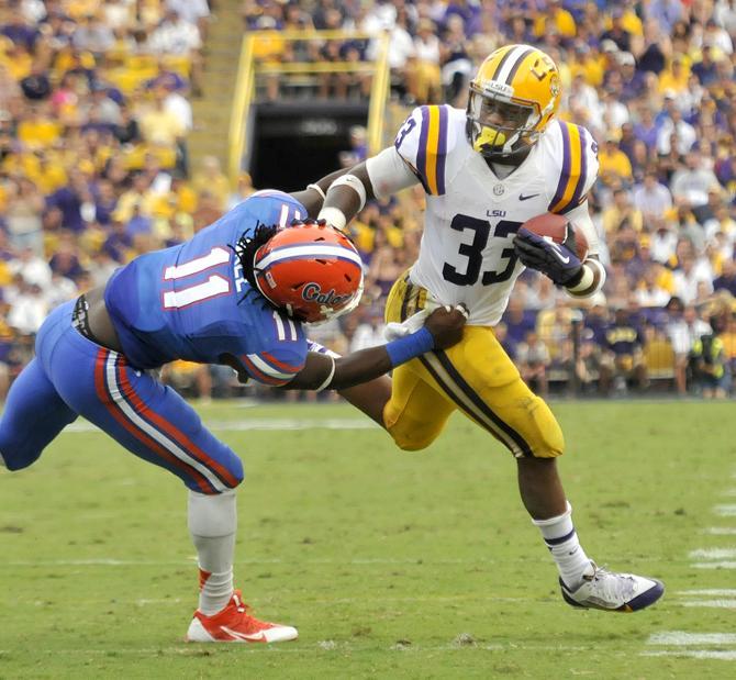 LSU sophomore running back Jeremy Hill rushes toward the first down Saturday, Oct. 12, 2013 during the Tigers' 17-6 victory against the Florida Gators in Tiger Stadium.