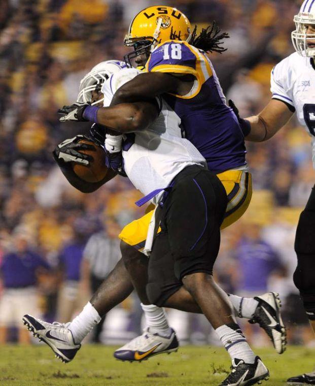 LSU senior linebacker Lamin Barrow (18) takes down a Furman defender Saturday, Oct. 26, 2013, during the Tigers' 48-16 win against Furman in Tiger Stadium.