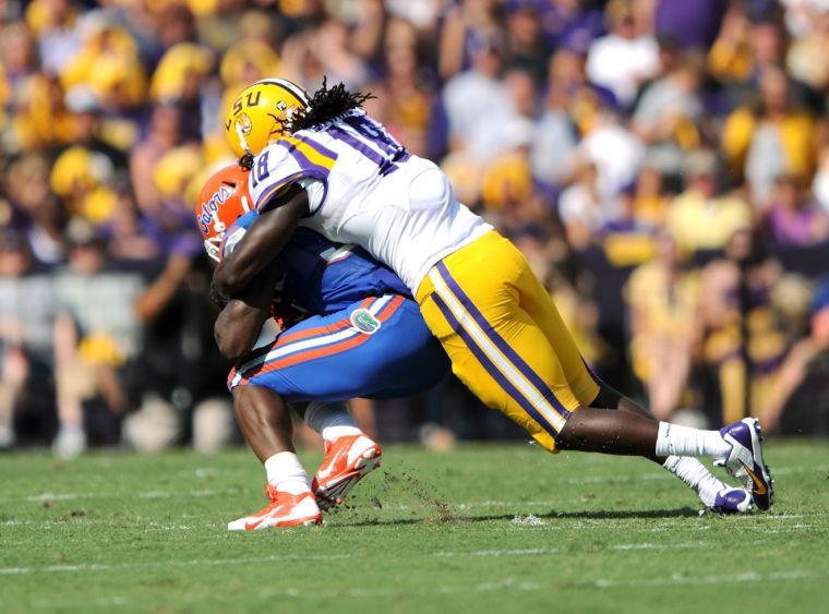 LSU senior linebacker Lamin Barrow (18) tackles Florida junior running back Mack Brown (33) Saturday, Oct. 12, 2013 during the Tigers' 17-6 victory against the Gators in Tiger Stadium.