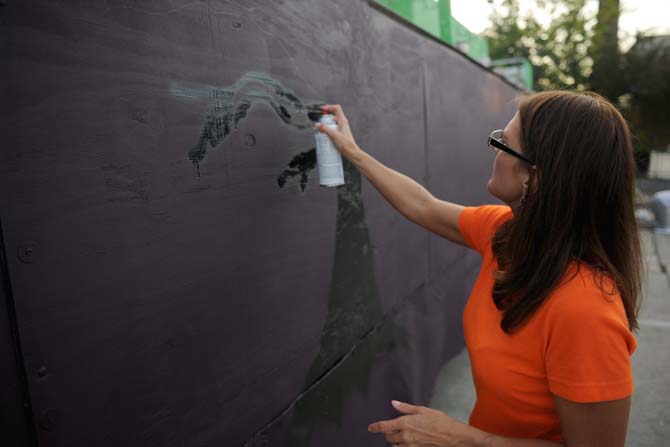 10/31 Consortium board member Deborah Trahan helps set up their float Tuesday, Oct. 15, 2013, for the upcoming 3rd Annual Halloween Parade on Saturday.