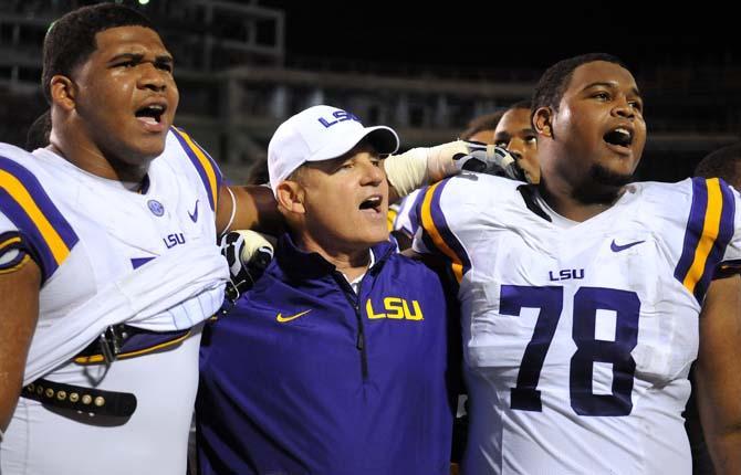 LSU coach Les Miles, junior left tackle La'el Collins (30), sophomore left guard Vadal Alexander (78) all sing the alma mater on Saturday October 5, 2013 during the 59-26 victory against Mississippi State in Davis Wade Stadium.