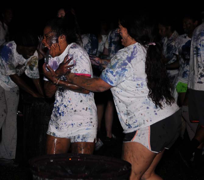 An LSU student gets splatted with paint by a fellow student on Monday, October 21, 2013, during the LSU Splatterbeat event as a part of homecoming week on the Parade Ground.