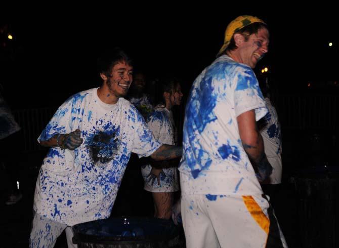 LSU history sophomore Michael Moore (left) flings paint at LSU kinesiology sophomore Samuel Sinquefield (right) on Monday, October 21, 2013, during the Splatterbeat homecoming week event on the Parade Ground.