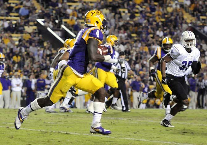 LSU senior running back Alred Blue (4) rushes the ball down the field Saturday, Oct. 26, 2013, during the Tigers' 48-16 win against Furman in Tiger Stadium.