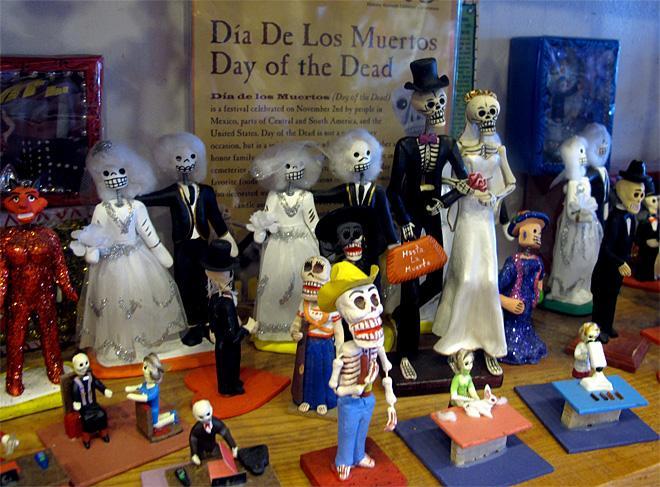 In this May 8, 2013 photo, artwork is shown at Masks y Mas, an Albuquerque shop that sells 'Day of the Dead' art year round. (AP Photo/Russell Contreras)