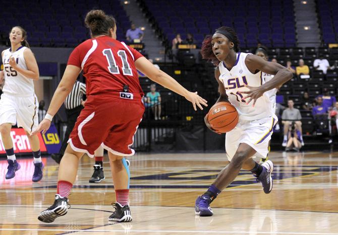 LSU freshman guard Raigyne Moncrief (11) drives past Tennessee Temple sophomore guard Kristina Pumpure (11) on Wednesday, Oct. 30, 2013 during the Lady Tiger's 95-24 victory agianst Tennessee Temple in the PMAC.