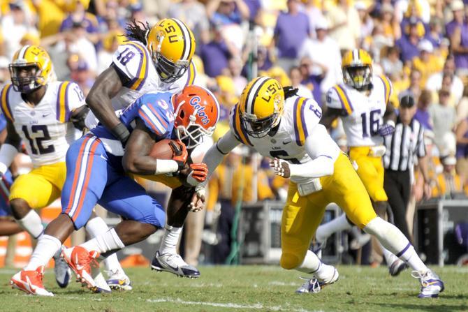 LSU senior linebacker Lamin Barrow (18) tackles Florida junior running back Mack Brown (33) on Saturday, Oct. 12, 2013 during the Tigers' 17-6 victory against the Gators in Tiger Stadium.