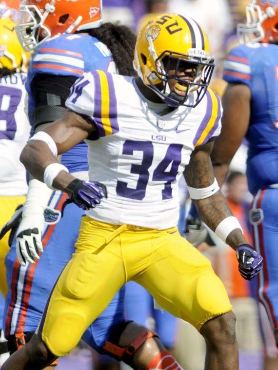 LSU sophomore safety Micah Eugene (34) celebrates after tackling a Florida ball carrier Saturday, Oct. 12, 2013 during the Tigers' 17-6 victory against the Gators in Tiger Stadium.