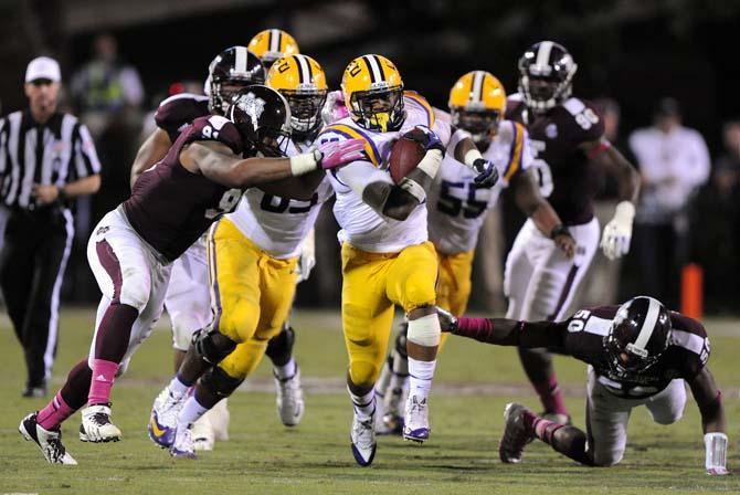 LSU sophomore running back Jeremy Hill (33) makes a run while warding off opposing players trying to tackle him on Saturday Oct. 5, 2013 during the 59-26 victory against Mississippi State in Davis Wade Stadium.