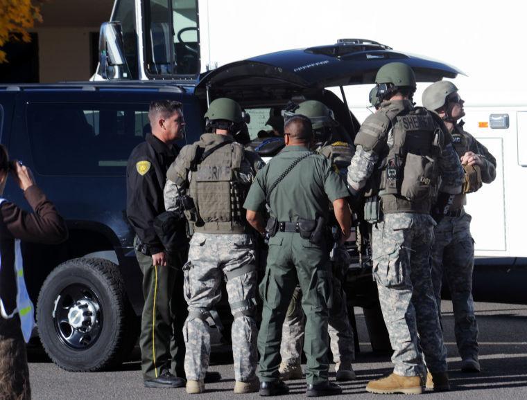 Law enforcement personnel gather at the scene of a shooting at Sparks Middle School in Sparks, Nev. on Monday, Oct. 21, 2013. A student at the school opened fire on campus just before the starting bell Monday, wounding two boys and killing a teacher who was trying to protect other children, Sparks police and the victim's family members said. (AP Photo/The Reno Gazette-Journal, Marilyn Newton) NO SALES; NEVADA APPEAL OUT; SOUTH RENO WEEKLY OUT