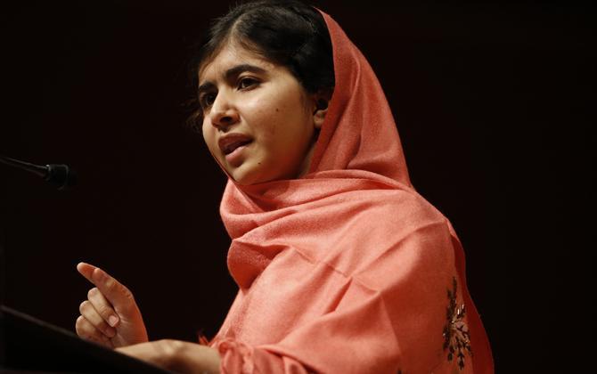 FILE - In this Friday, Sept. 27, 2013 file photo, Malala Yousafzai addresses students and faculty after receiving the 2013 Peter J. Gomes Humanitarian Award at Harvard University, on the school's campus in Cambridge, Mass. A year ago, Malala Yousafzai was a schoolgirl in northwest Pakistan, thinking about calculus and chemistry, Justin Bieber songs and "Twilight" movies. Today she's the world-famous survivor of a Taliban assassination attempt, an activist for girls' education _ and a contender to win the Nobel Peace Prize on Friday Oct. 11, 2013. (AP Photo/Jessica Rinaldi, File)