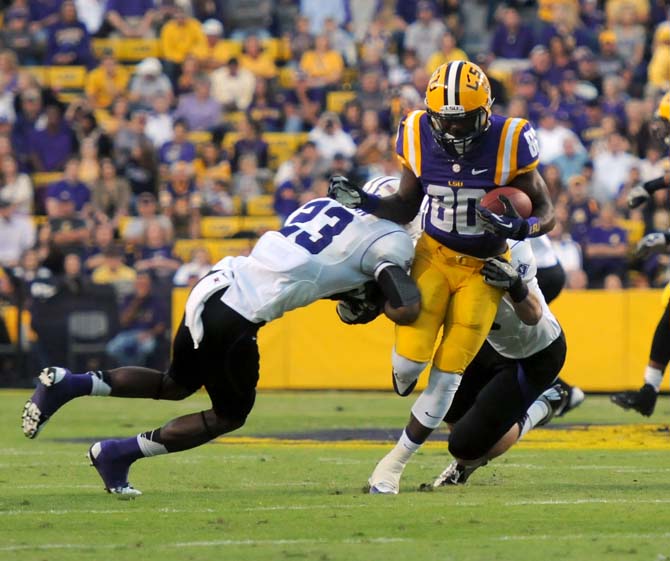 LSU junior wide reciever Jarvis Landry (80) runs between two Furman defenders Saturday, Oct. 26, 2013 during the Tigers' 48-16 win against the Paladins in Tiger Stadium.