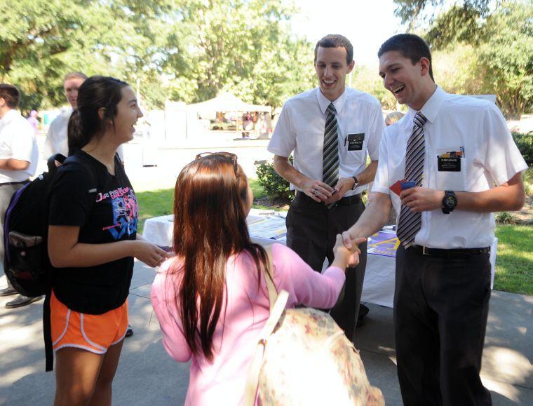 Mormon missionaries Elder Knowlton and Elder Howard speak to freshmen Alexis Pastrana and Clara Isabelle Merca Bausa Wednesday, Oct. 9 in the LSU Free Speech Plaza.