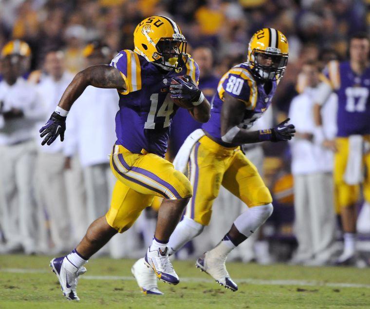 LSU junior running back Terrence Magee (14) runs the ball alongside LSU junior wide receiver Jarvis Landry (80) on Saturday night, Oct. 26, 2013 during the Tigers' 48-16 win against Furman in Tiger Stadium.