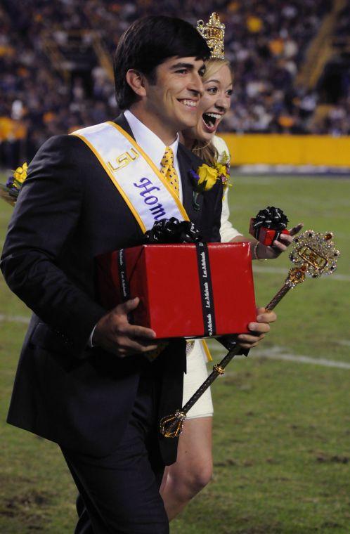 The newly crowned homecoming queen Emma Arseneaux and king Alex Cagnola walk off field Saturday night, Oct. 26, 2013 during the Tigers' 48-16 win against Furman in Tiger Stadium.