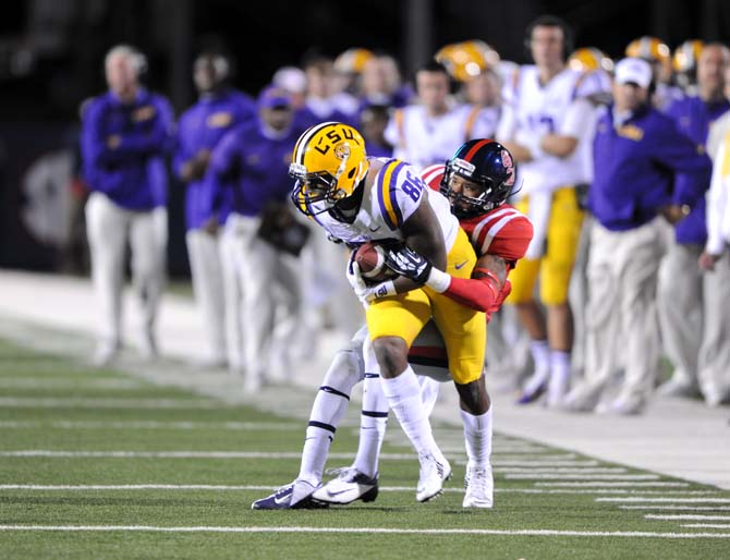 An Ole Miss defensive player tackles LSU senior wide receiver Kadron Boone (86) on Saturday, October 19, 2013 during the Tigers' 27-24 loss against the Rebels at Vaught-Hemingway Stadium.