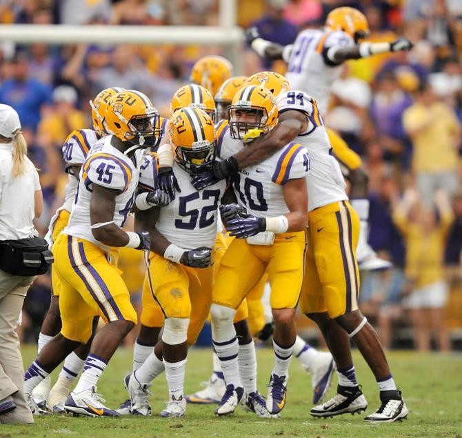 LSU defensive players celebrate a fourth down stop Saturday, Oct. 12, 2013 during the Tigers' 17-6 victory against the Gators in Tiger Stadium.