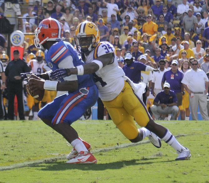 LSU sophomore safety Micah Eugene (34) sacks Florida junior quarterback Tyler Murphy (3) on Saturday, Oct. 12, 2013 during the Tigers' 17-6 victory against the Gators in Tiger Stadium.