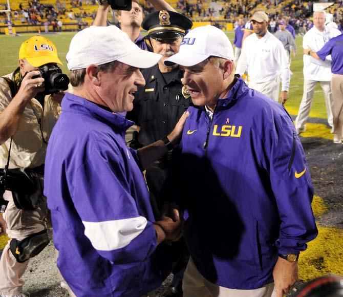 LSU head football coach Les Miles (right) shakes hands with Furman head coach Bruce Fowler (left) following the Tigers' 48-16 win against the Paladins in Tiger Stadium.