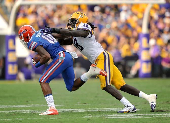 LSU senior line backer Lamin Barrow (18) tackles Florida sophomore running back Valdez Showers (10) during the Tigers' 17-6 victory against the Gators in Tiger Stadium.