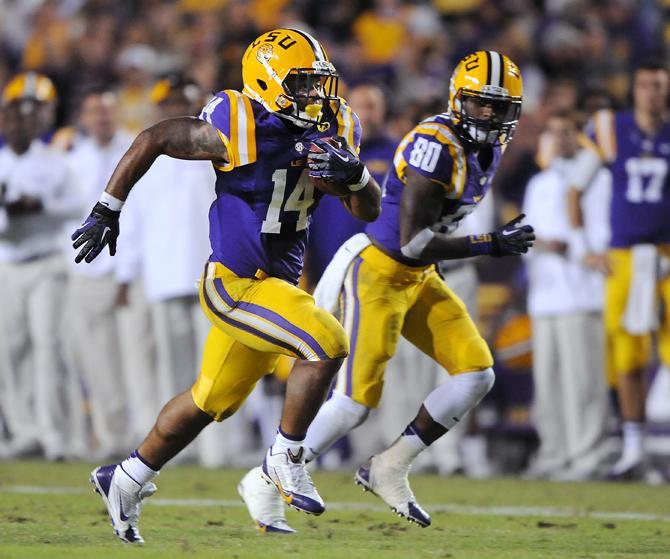 LSU junior running back Terrence Magee (14) runs the ball alongside LSU junior wide receiver Jarvis Landry (80) on Saturday night, Oct. 26, 2013 during the Tigers' 48-16 win against Furman in Tiger Stadium.