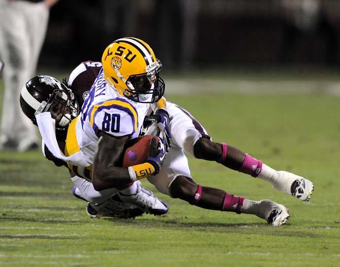 LSU junior wide receiver Jarvis Landry (80) protects the ball as he gets thrown to the ground by an opposing player on Saturday Oct. 5, 2013 during the 59-26 victory against Mississippi State in Davis Wade Stadium.