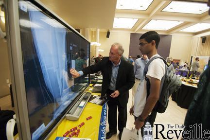 Computer science graduate student Swapnil Veer looks at the Sharp Electronics interactive white board at the Techpawlooza held in the LSU Student Union on Wedensday.