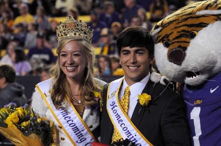 The newly crowned homecoming queen Emma Arseneaux and king Alex Cagnola pose next to Mike on Saturday night, Oct. 26, 2013 during the Tigers' 48-16 win against Furman in Tiger Stadium.