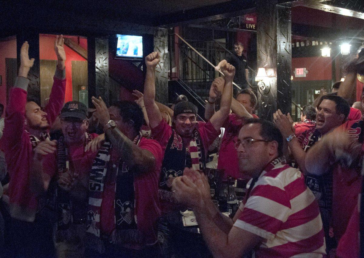 Craig Dupuy and other members of American Outlaws of Baton Rouge celebrate the USA soccer victory over Mexico on Tuesday, Sept. 10, 2013, at The Londoner Pub and Grill.