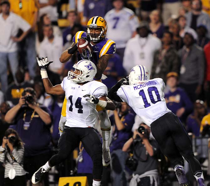 LSU junior wide reciever Odell Beckham Jr. (3) leaps over Furman sophomore cornerback Reggie Thomas (14) and junior free safety Marcus McMorris (10) to catch a touchdown pass Saturday, Oct. 26, 2013 during the Tigers' 48-16 win against the Paladins in Tiger Stadium.