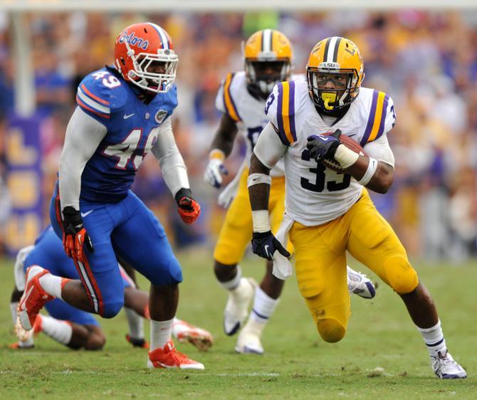 LSU sophomore running back Jeremy Hill rushes toward the first down Saturday, Oct. 12, 2013 during the Tigers' 17-6 victory against the Florida Gators in Tiger Stadium.