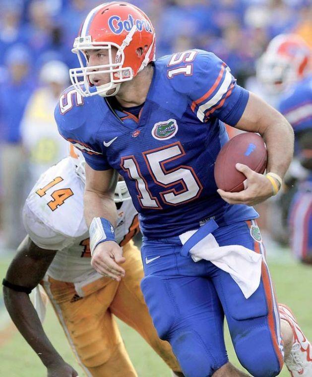 Florida quarterback Tim Tebow (15) runs for yardage as he is chased by Tennessee cornerback Eric Berry (14) during the second half of an NCAA college football game in Gainesville, Fla., Saturday, Sept. 19, 2009. Florida won 23-13.(AP Photo/John Raoux)