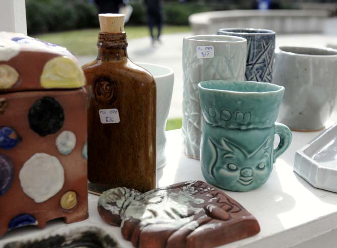 A few original, handmade pieces of ceramic art stand on shelves for sale on Tuesday, November 19, 2013, during the LSU Art and Design ceramics sale in Free Speech Alley.