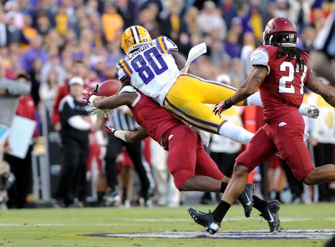 LSU junior wide receiver Jarvis Landry (80) leaps to catch a pass from senior quarterback Zach Mettenberger Friday, Nov. 29, 2013 during the Tigers' 31-27 victory against Arkansas in Tiger Stadium.