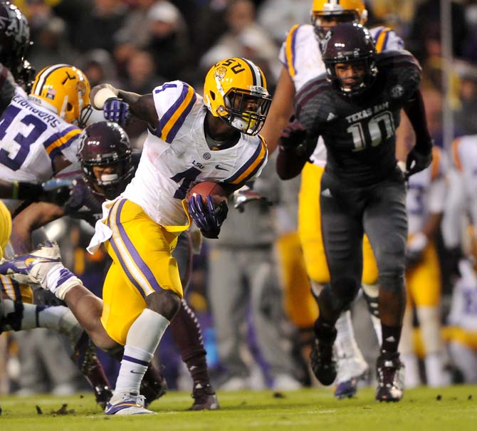 LSU senior running back Alfred Blue rushes for a first down Saturday, Nov. 20, 2013 during the Tiger's 34-10 victory against the Aggies.