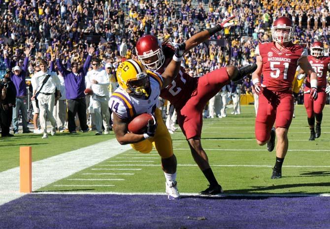 LSU junior running back Terrence Magee (14) stumbles across the goal line Friday, Nov. 29, 2013 during the Tigers' matchup against Arkansas. The Razorbacks lead the Tigers 17-14 at the half.