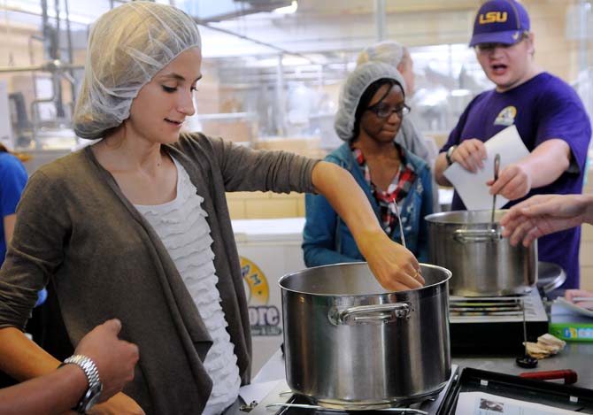 LSU food science graduate student Samantha Stein stirs the pot in the process of making cottage cheese Thursday, Oct. 31, 2013, in the Dairy Science Building.