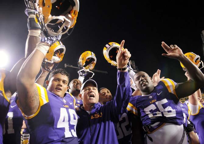 LSU head football coach Les Miles celebrates with his team Saturday, Oct. 26, 2013 following the Tigers' 48-16 win against Furman in Tiger Stadium.