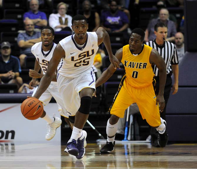 LSU freshman forward Jordan Mickey (25) weaves past Xavier junior forward Sydney Coleman (0) Wednesday, Nov. 6, 2013, during the Tigers' 80-45 victory at the Pete Maravich Assembly Center