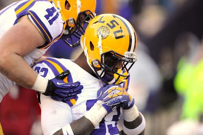 LSU sophomore running back Jeremy Hill (33) and junior tight end Travis Dickson (41) celebrate in the endzone Friday, Nov. 29, 2013 during the Tigers' 31-27 victory against Arkansas in Tiger Stadium.