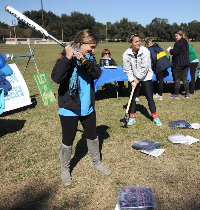 Kinesiology junior Katherine Cuntz (left) and biology freshman Madison North swing at scales Wednesday, November 13, 2013 at the Southern Smash event on the Parade Grounds.