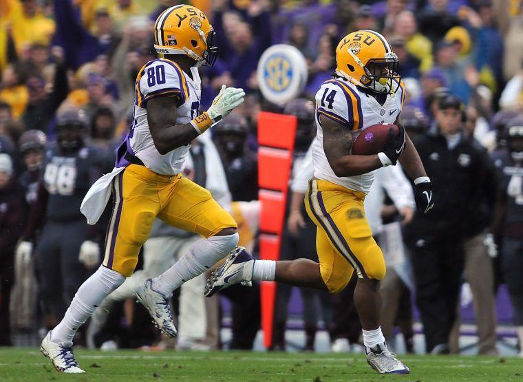 LSU junior running back Terrence Magee (14) carries the ball downfield as LSU junior wide receiver Jarvis Landry (80) runs alongside him Saturday Nov. 23, 2013 during the Tigers' 34-10 victory against Texas A&amp;M in Tiger Stadium.