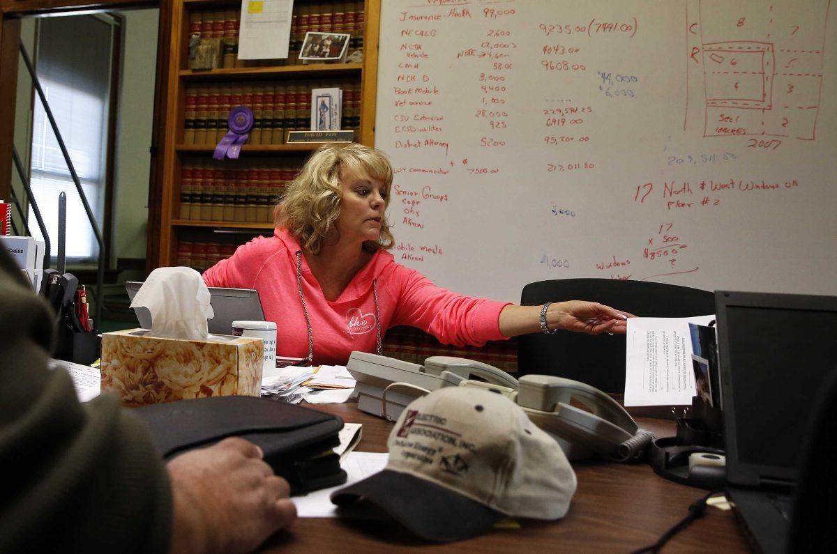 In this Nov. 6, 2013 photo, Washington County Commissioner Lea Ann Laybourn works in her office in the rural town of Akron, the county seat of Washington County, Colo. A day earlier, a majority in Washington and four other counties on Colorado&#8217;s Eastern Plains voted yes on the creation of a 51st state, largely over residents' alienation from voters statewide on issues such as civil unions for gay couples, new renewable energy standards, and limits on ammunition magazines. (AP Photo/Brennan Linsley)