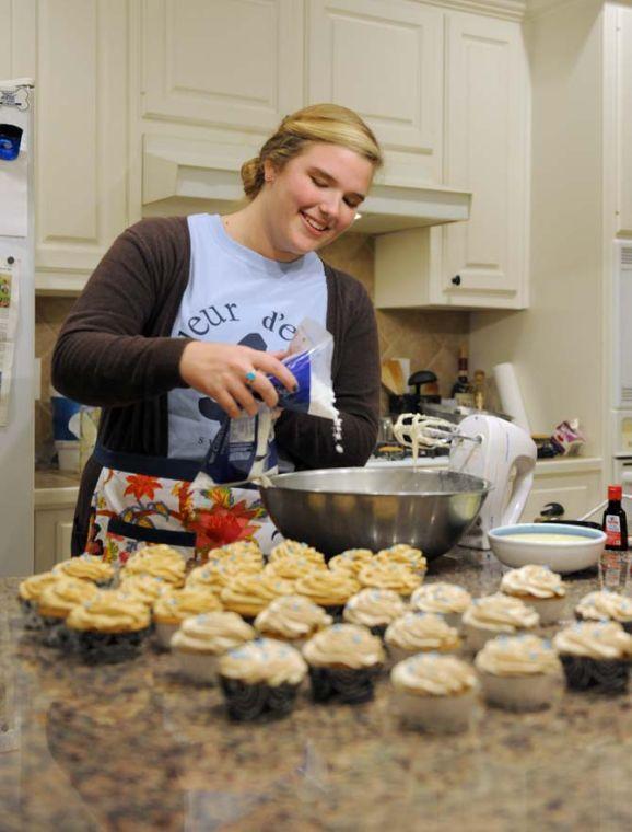 LSU Spanish junior Elise Abshire of Fleur D'Elise Treats adds powdered sugar to her icing mix Monday, Nov. 11, 2013 in her home in Baton Rouge.