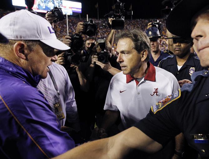 Alabama head coach Nick Saban, right, greets LSU head coach Les Miles after their NCAA college football game in Baton Rouge, La., Saturday, Nov. 3, 2012. Alabama won 21-17. (AP Photo/Gerald Herbert)