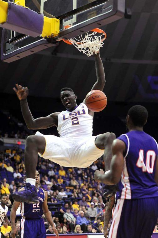 LSU junior forward Johnny O'Bryant III (2) hangs from the rim Saturday, Nov. 16, 2013 during the Tigers' 88-74 victory against Northwestern State in the PMAC.