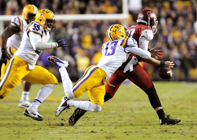 LSU freshman cornerback Dwayne Thomas (13) knocks the football from the hands of Arkansas sophomore quarterback Brandon Allen (10) Friday, Nov. 29, 2013 during the Tigers' 31-27 victory against the Razorbacks in Tiger Stadium.