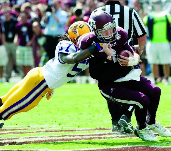 LSU junior linebacker Lamin Barrow (57) brings down Texas A&amp;M freshman quarterback Johnny Manziel (2) on Saturday, Oct, 20, 2012 at Kyle Field in College Station, Texas.