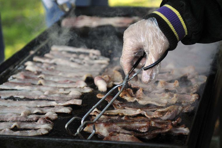 Mechanical Engineering senior and Kitchens on the Geaux cofounder Scott Burke cooks bacon for the homeless of Baton Rouge Sunday morning Nov. 24, 2013 at Expressway Park.