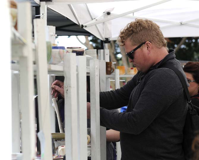 A guy looks looks at some of the pottery on Tuesday, November 19, 2013, during the LSU Art and Design ceramics sale in Free Speech Alley.